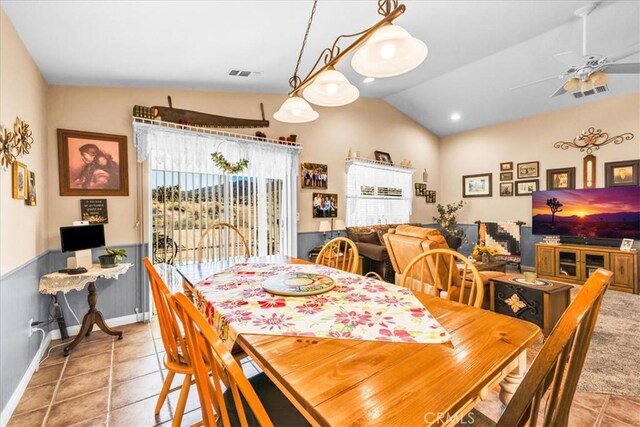 dining area featuring visible vents, a ceiling fan, lofted ceiling, and light tile patterned floors