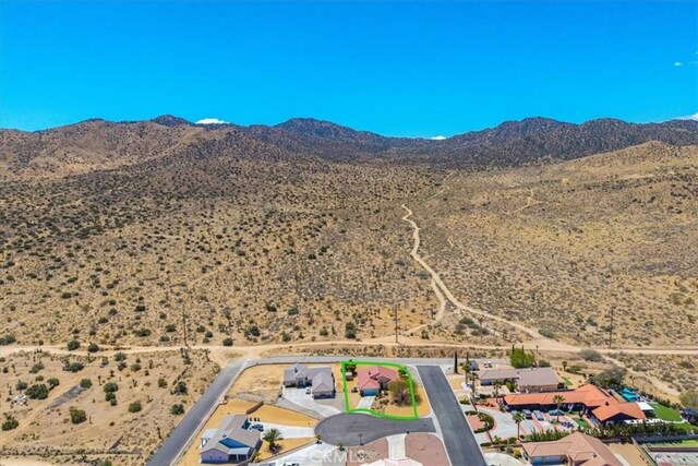 birds eye view of property featuring a rural view, a mountain view, and a desert view