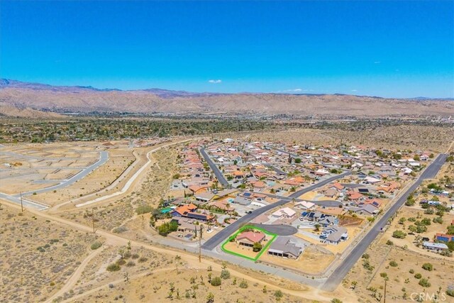bird's eye view featuring a desert view, a mountain view, and a residential view