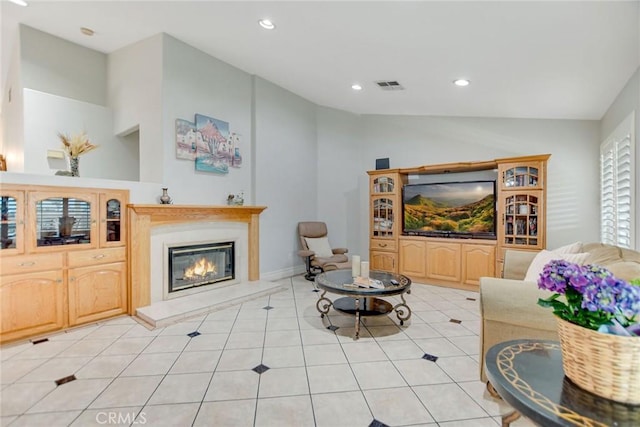 living room featuring visible vents, recessed lighting, a glass covered fireplace, and light tile patterned floors