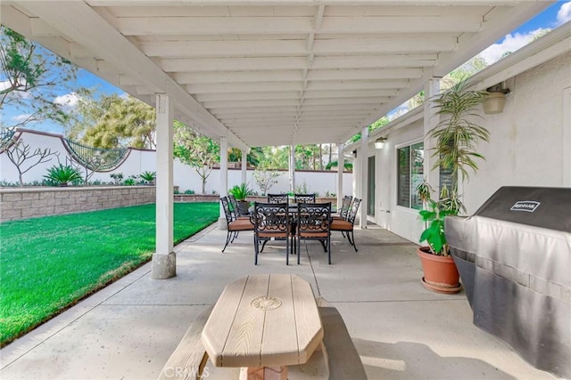 view of patio / terrace with a fenced backyard, outdoor dining area, and grilling area