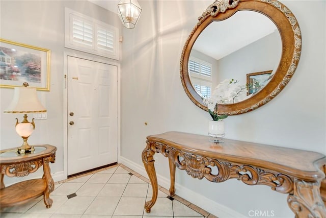 foyer entrance with baseboards and light tile patterned floors
