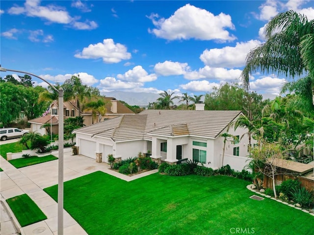 single story home with a garage, fence, a front yard, a chimney, and driveway