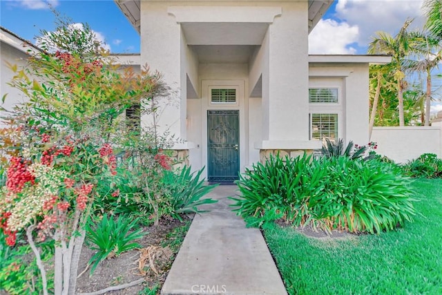 doorway to property with stucco siding