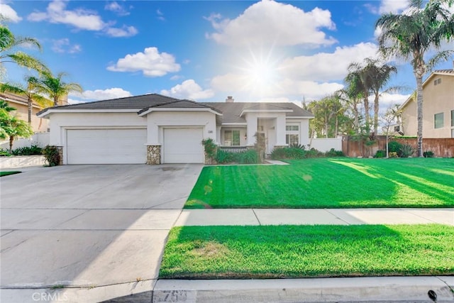 view of front of property featuring driveway, a front yard, a garage, fence, and stucco siding