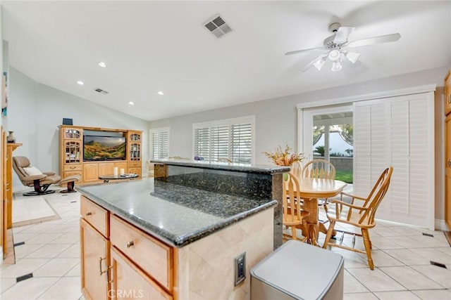 kitchen with recessed lighting, a ceiling fan, light tile patterned floors, a kitchen island, and visible vents