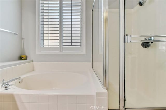 full bath with a garden tub and a stall shower