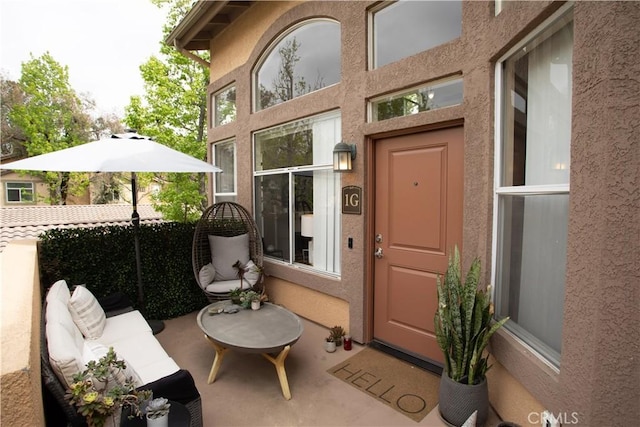 doorway to property featuring stucco siding