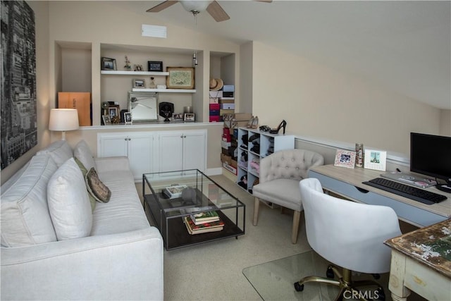 carpeted home office featuring ceiling fan