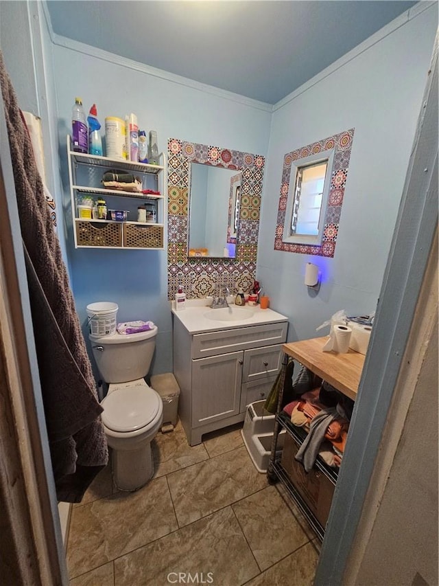 31940 Zircon Rd, Lucerne Valley, CA 92356 - bathroom with crown molding, tile patterned flooring, toilet, and vanity
