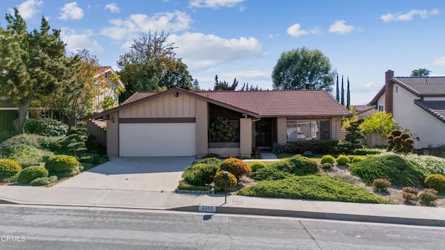 ranch-style home featuring a garage, stucco siding, concrete driveway, and a tile roof