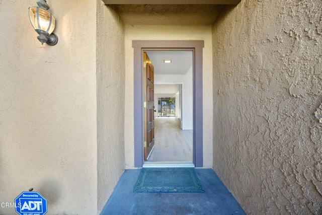 doorway to property featuring stucco siding
