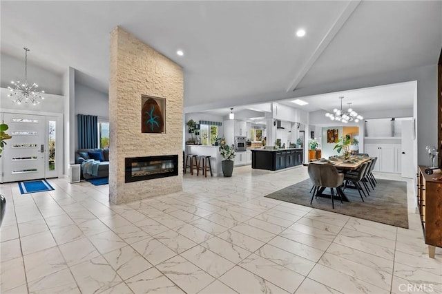 2450 Cameron Ave, Covina, CA 91724 - living room featuring a fireplace, vaulted ceiling, a notable chandelier, marble finish floor, and recessed lighting