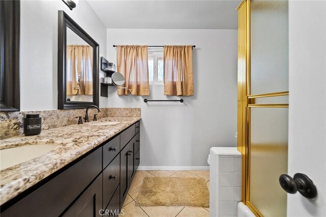 2450 Cameron Ave, Covina, CA 91724 - full bathroom with double vanity, a sink, tile patterned floors, baseboards, and a shower with door