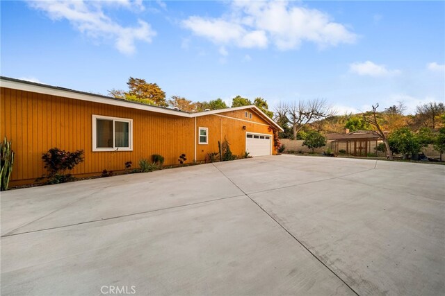 2450 Cameron Ave, Covina, CA 91724 - view of side of property featuring an attached garage and driveway