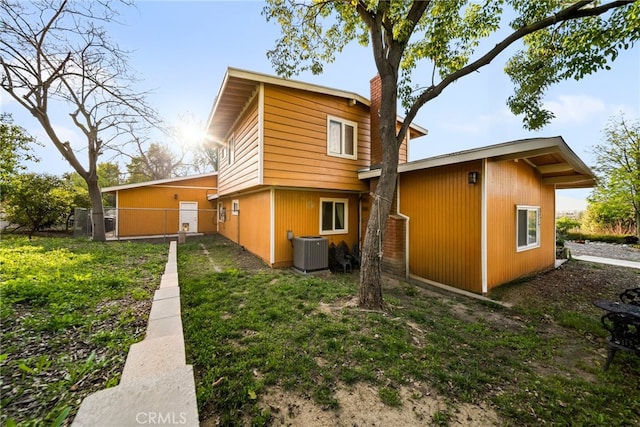 2450 Cameron Ave, Covina, CA 91724 - back of property featuring central air condition unit, fence, and a chimney