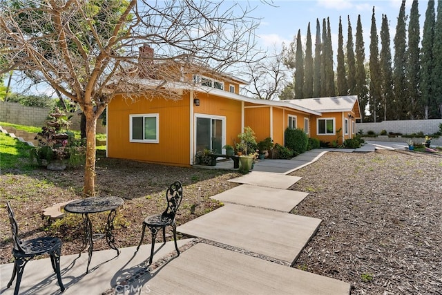 2450 Cameron Ave, Covina, CA 91724 - view of front of house with a patio, fence, and a chimney