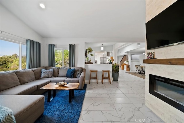 2450 Cameron Ave, Covina, CA 91724 - living area with a glass covered fireplace, marble finish floor, recessed lighting, vaulted ceiling, and visible vents