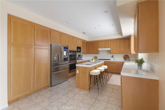 19131 Camassia Ct, Riverside, CA 92508 - kitchen featuring stainless steel appliances, a kitchen breakfast bar, a center island, light tile patterned floors, and recessed lighting