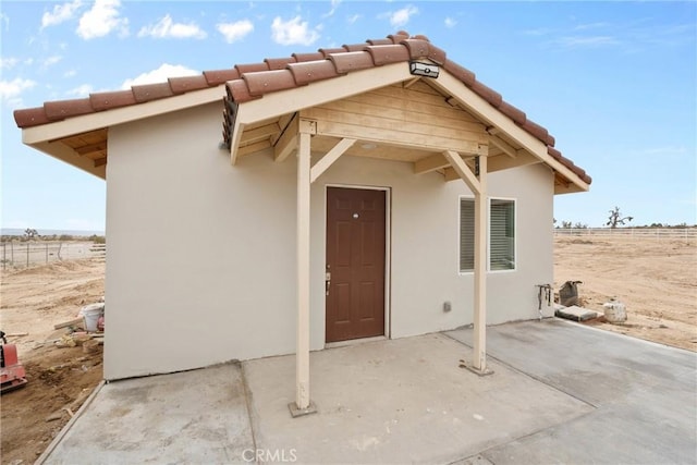 12185 Atsina Rd, Phelan, CA 92371 - exterior space featuring a patio, stucco siding, and a tiled roof