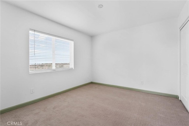 12185 Atsina Rd, Phelan, CA 92371 - carpeted spare room featuring baseboards