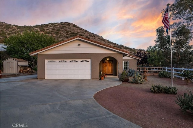 33660 White Feather Rd, Acton, CA 93510 - view of front facade with driveway, a mountain view, stucco siding, and a garage