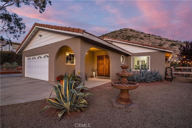 33660 White Feather Rd, Acton, CA 93510 - ranch-style house with a tiled roof, a garage, driveway, stucco siding, and a mountain view