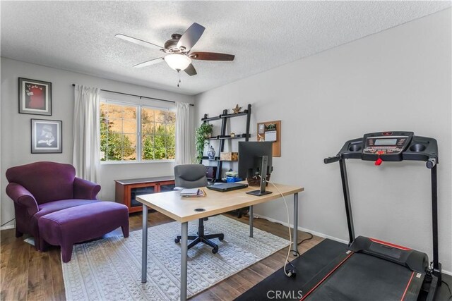 33660 White Feather Rd, Acton, CA 93510 - home office featuring a textured ceiling, wood finished floors, a ceiling fan, and baseboards