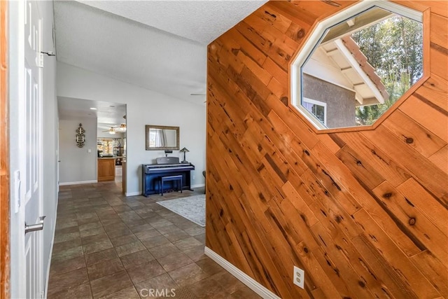 33660 White Feather Rd, Acton, CA 93510 - staircase with lofted ceiling, wooden walls, ceiling fan, and baseboards