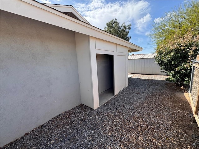 exterior space featuring fence and stucco siding