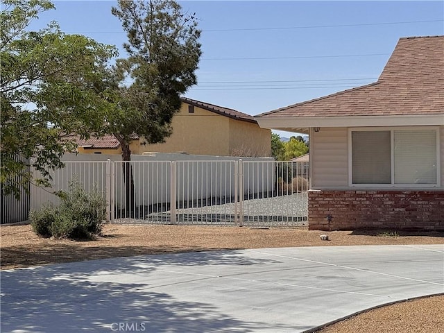 view of gate with fence