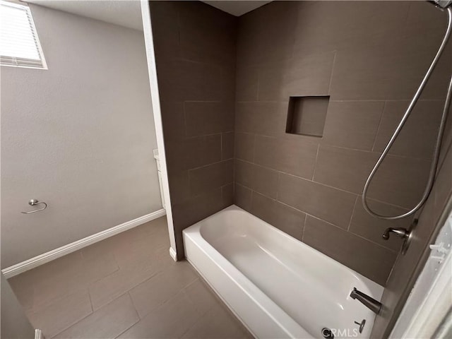 bathroom with tile patterned floors, bathing tub / shower combination, and baseboards