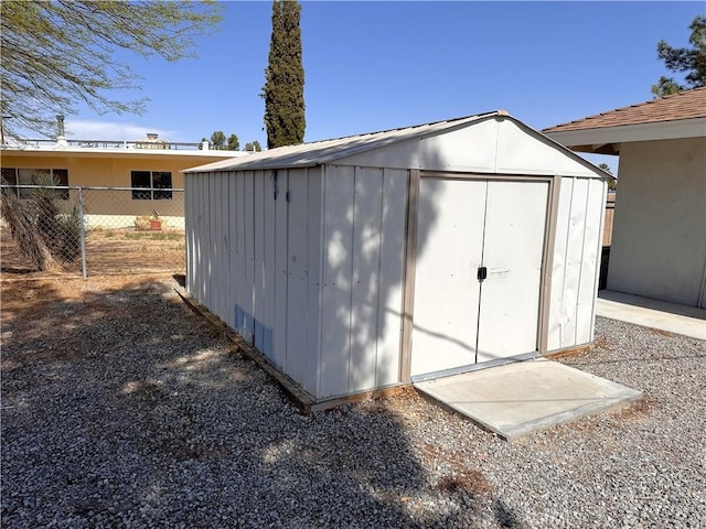 view of shed with fence