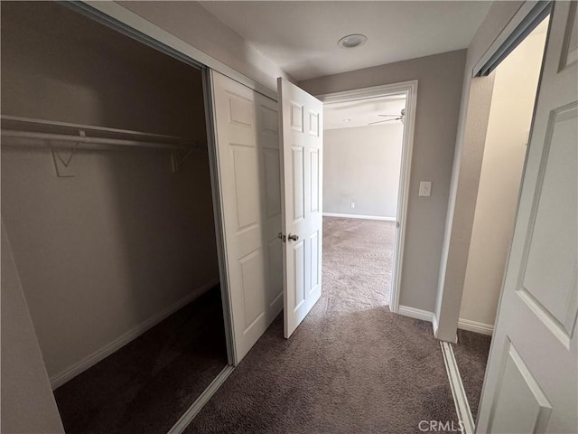 interior space with baseboards and carpet