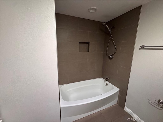 full bathroom with  shower combination, baseboards, and tile patterned flooring