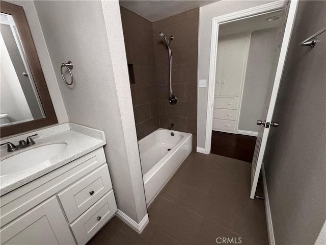 full bathroom with shower / bath combination, baseboards, tile patterned flooring, and vanity