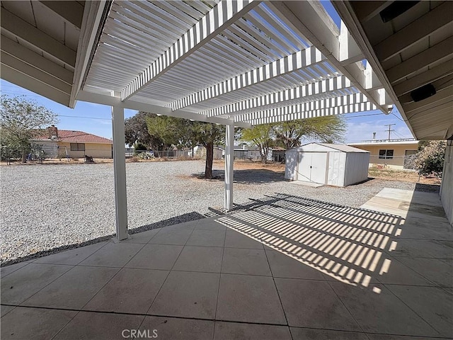 view of patio / terrace featuring a pergola, an outbuilding, and a shed