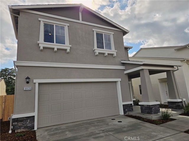 traditional home with an attached garage, stucco siding, and stone siding