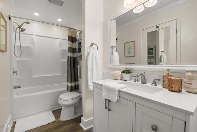bathroom featuring vanity, toilet, wood finished floors, shower / tub combo, and ornamental molding