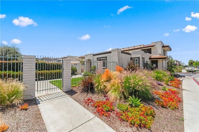 contemporary house with a gate, stucco siding, and fence private yard
