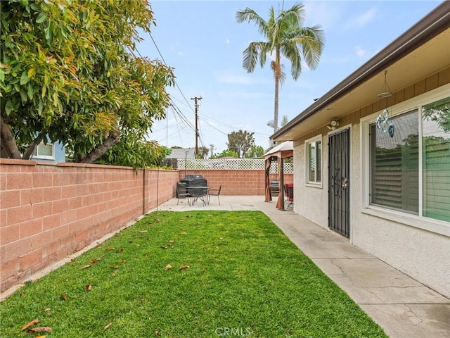 view of yard with a fenced backyard and a patio area