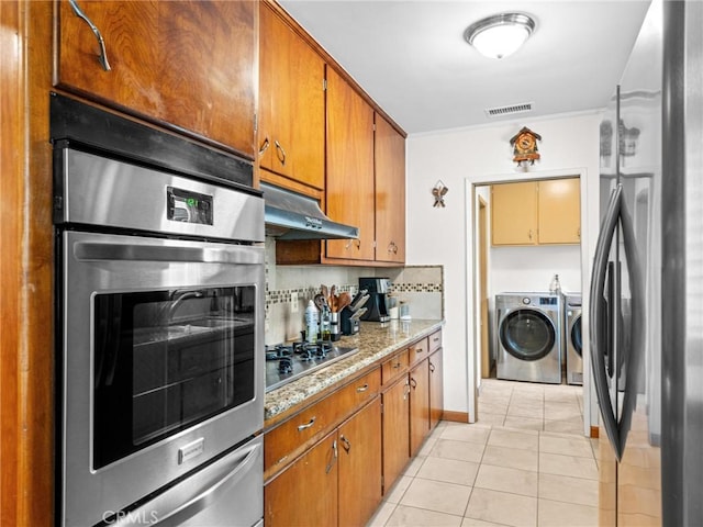 kitchen with visible vents, appliances with stainless steel finishes, light tile patterned floors, a warming drawer, and under cabinet range hood