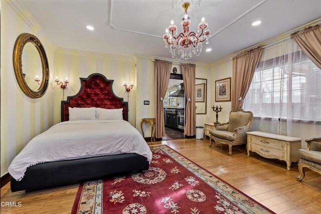 1900 Taft Ave, Los Angeles, CA 90068 - bedroom with recessed lighting, ornamental molding, wood finished floors, and a chandelier