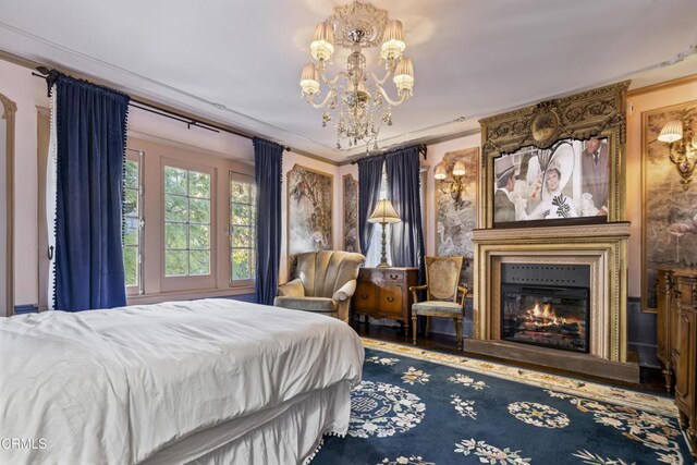 1900 Taft Ave, Los Angeles, CA 90068 - bedroom with a notable chandelier, a large fireplace, and wood finished floors