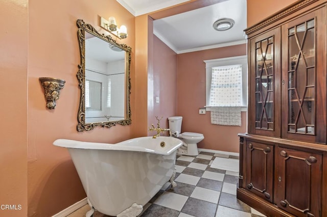 1900 Taft Ave, Los Angeles, CA 90068 - full bathroom with crown molding, a freestanding tub, toilet, baseboards, and tile patterned floors