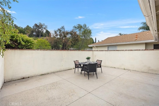 view of patio / terrace featuring fence and outdoor dining area