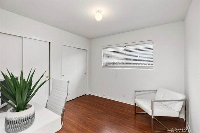 unfurnished room with baseboards and wood finished floors