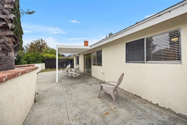 view of patio / terrace featuring fence