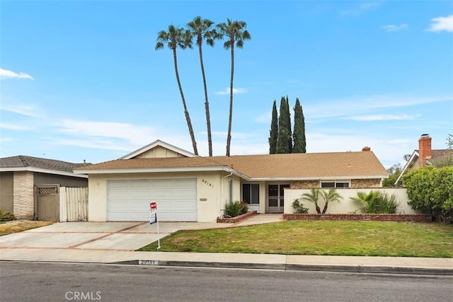 single story home with fence, a garage, stucco siding, a front yard, and driveway