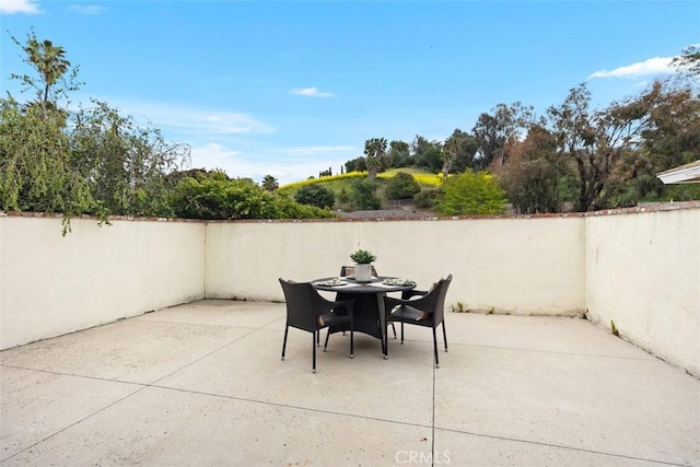 view of patio / terrace featuring fence and outdoor dining area